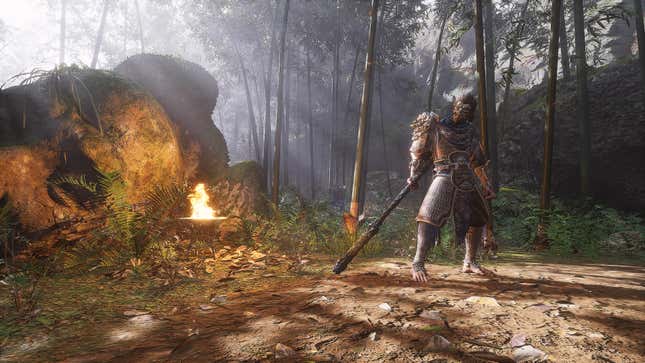 An image from Black Myth: Wukong shows an armored figure standing in a forest near a large boulder and a fire.